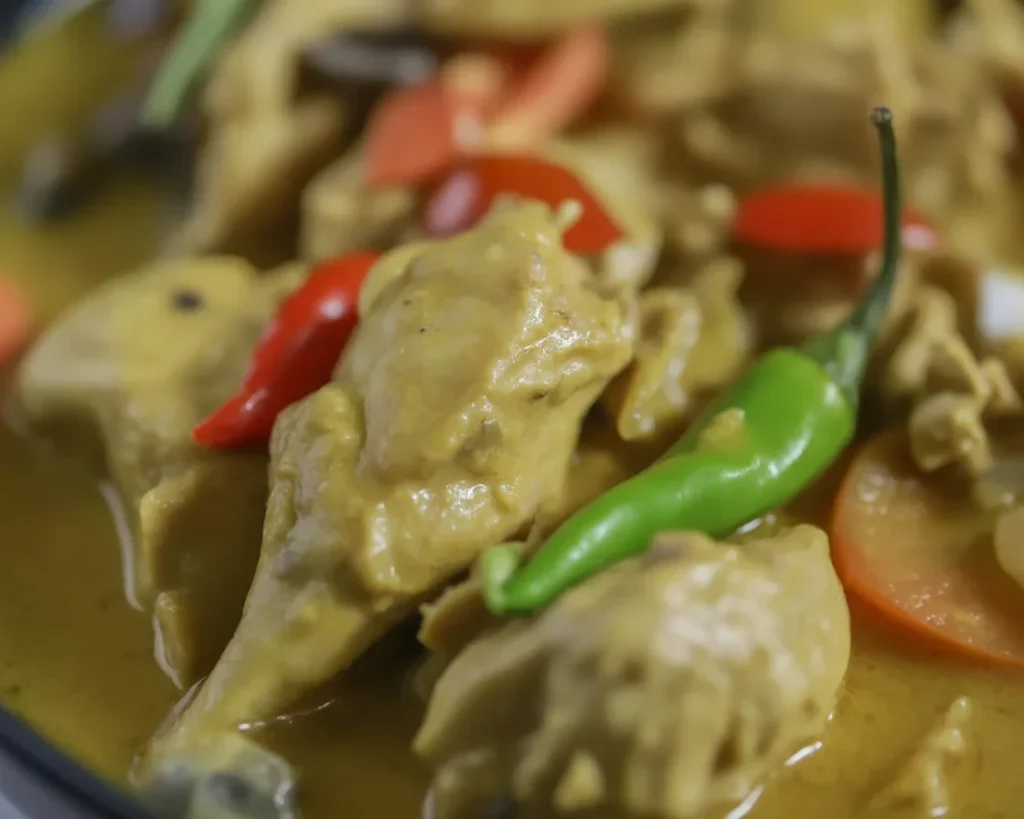 Filipino chicken curry with coconut milk, bell peppers, and vegetables in a creamy sauce