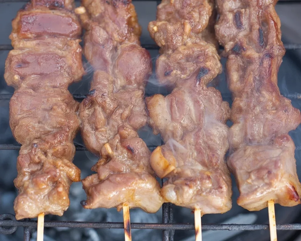 Delicious Filipino barbecue pork skewers grilled and glazed with sweet savory sauce.