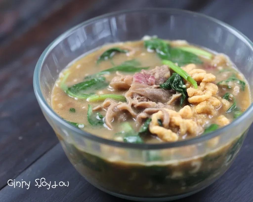 A delicious bowl of Filipino ginisang monggo with mung beans, coconut milk, and vegetables.