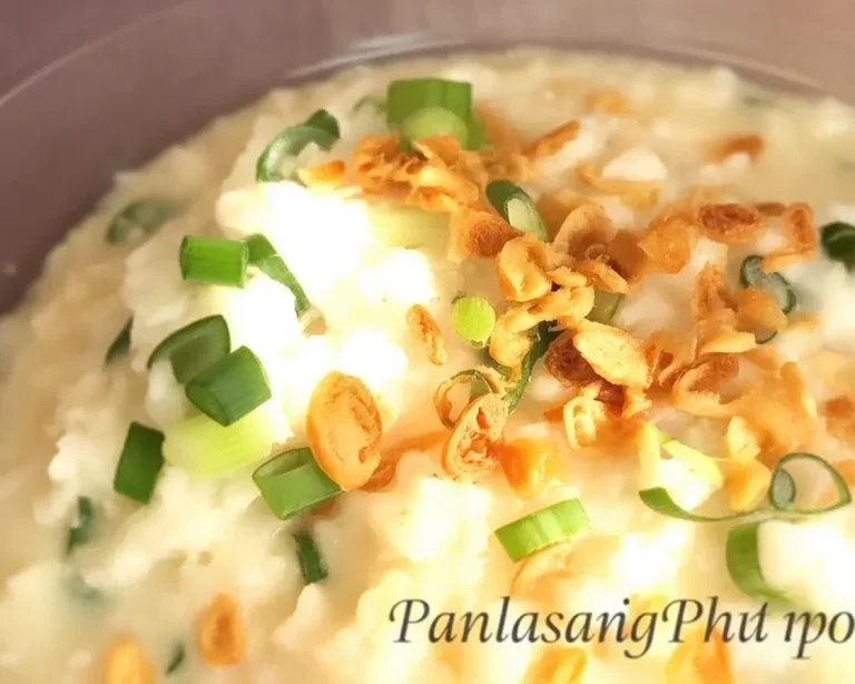 Bowl of Filipino goto, a rice congee with beef tripe and ginger, garnished with garlic.