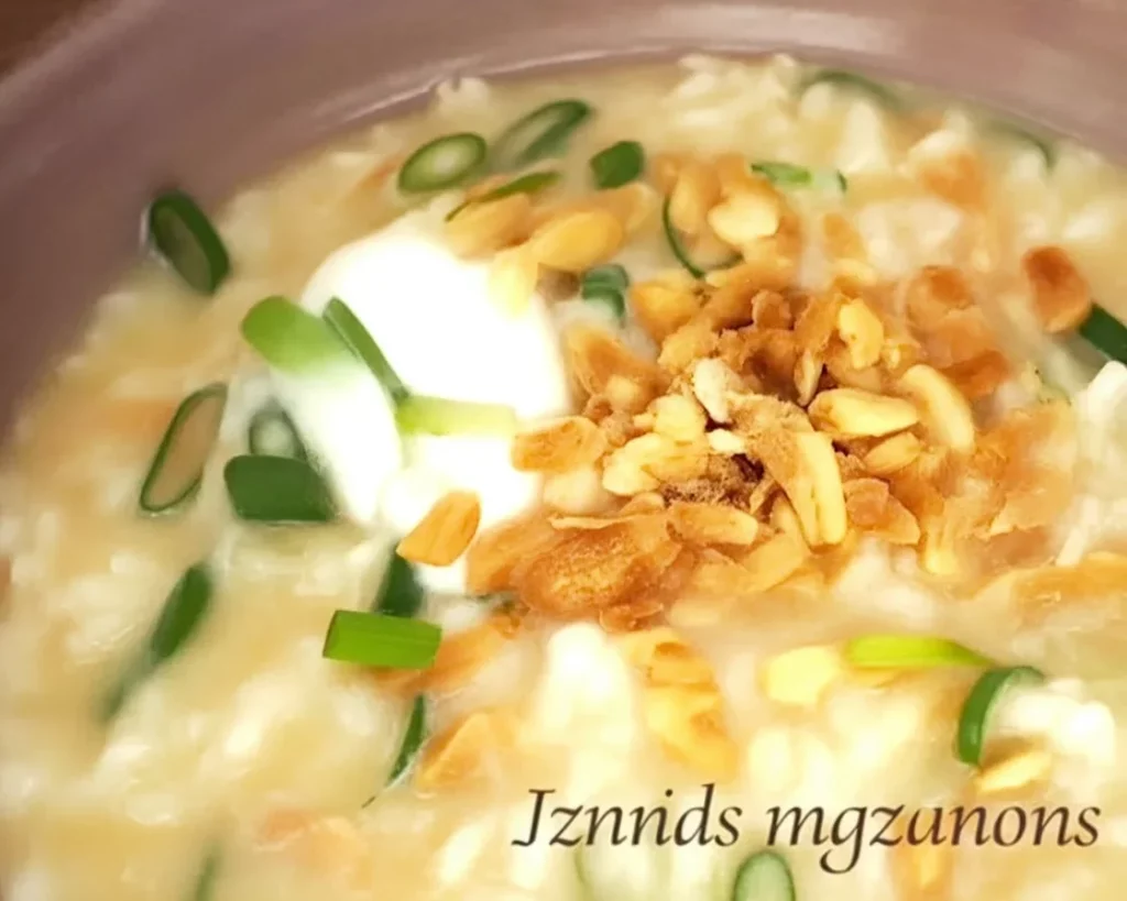 A bowl of Filipino goto, beef tripe rice porridge topped with garlic and spices.