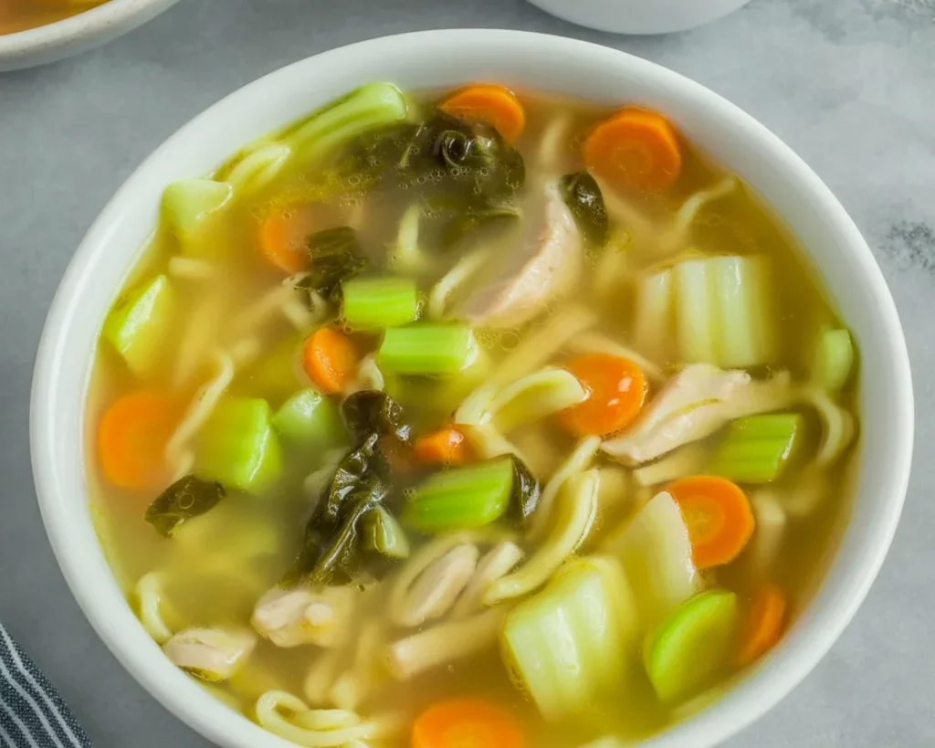 Bowl of Filipino Pancit Lomi with thick egg noodles and fresh ingredients