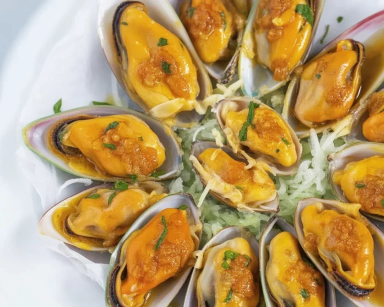Delicious Filipino inihaw na tahong served with butter and garlic on a plate.