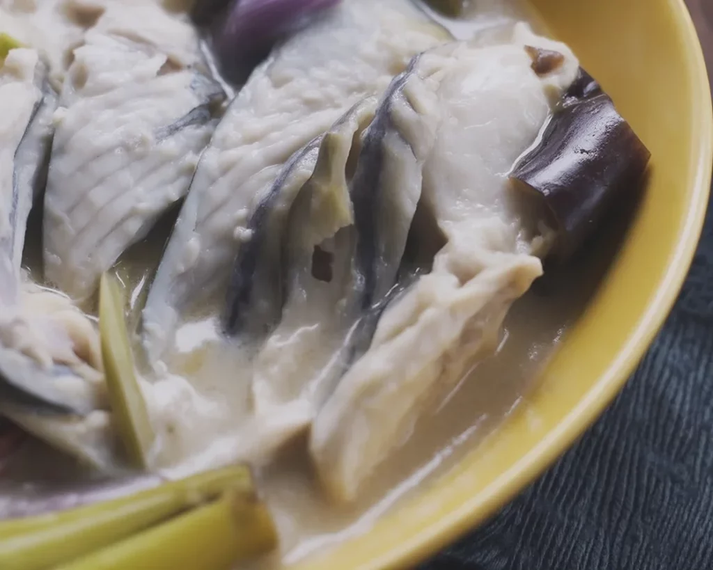 Filipino paksiw na bangus dish featuring milkfish stewed in vinegar and spices.