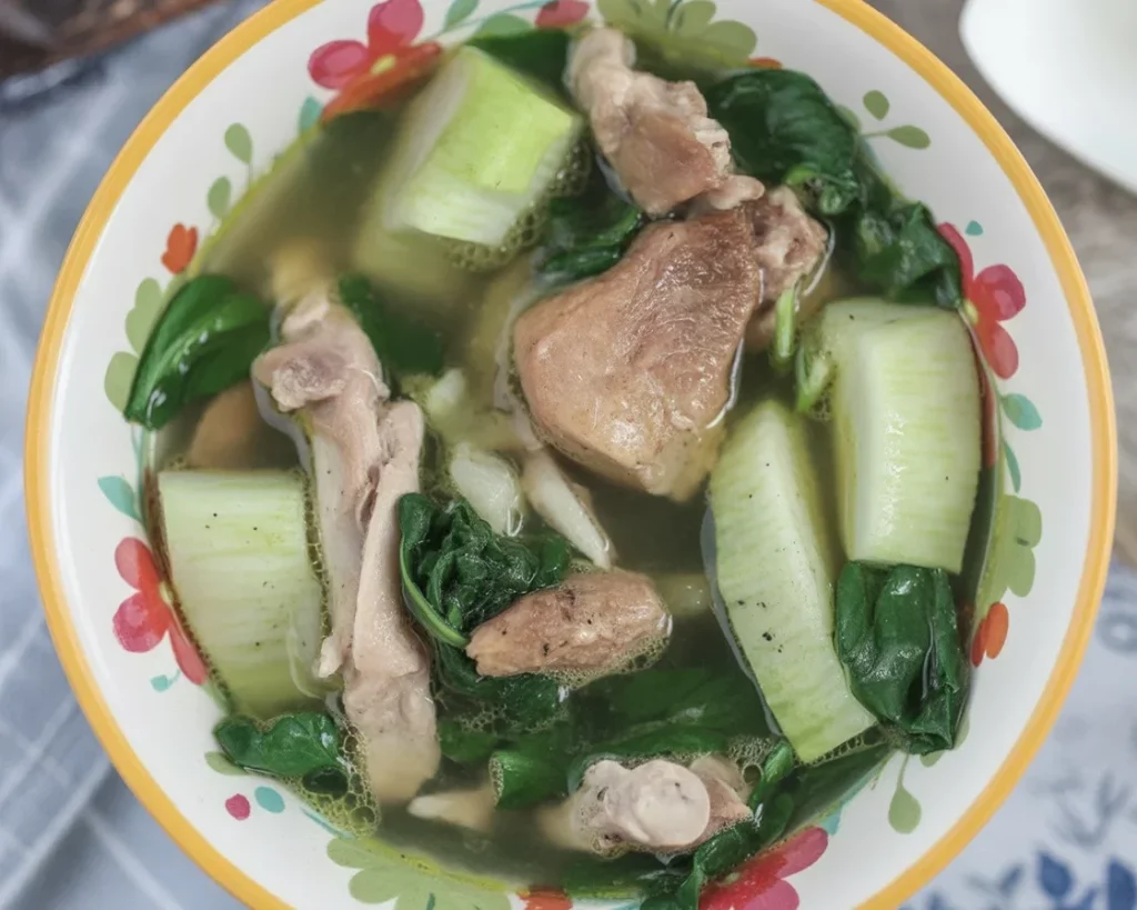Bowl of traditional Tinolang Manok sa Papaya, a comforting Filipino chicken soup.