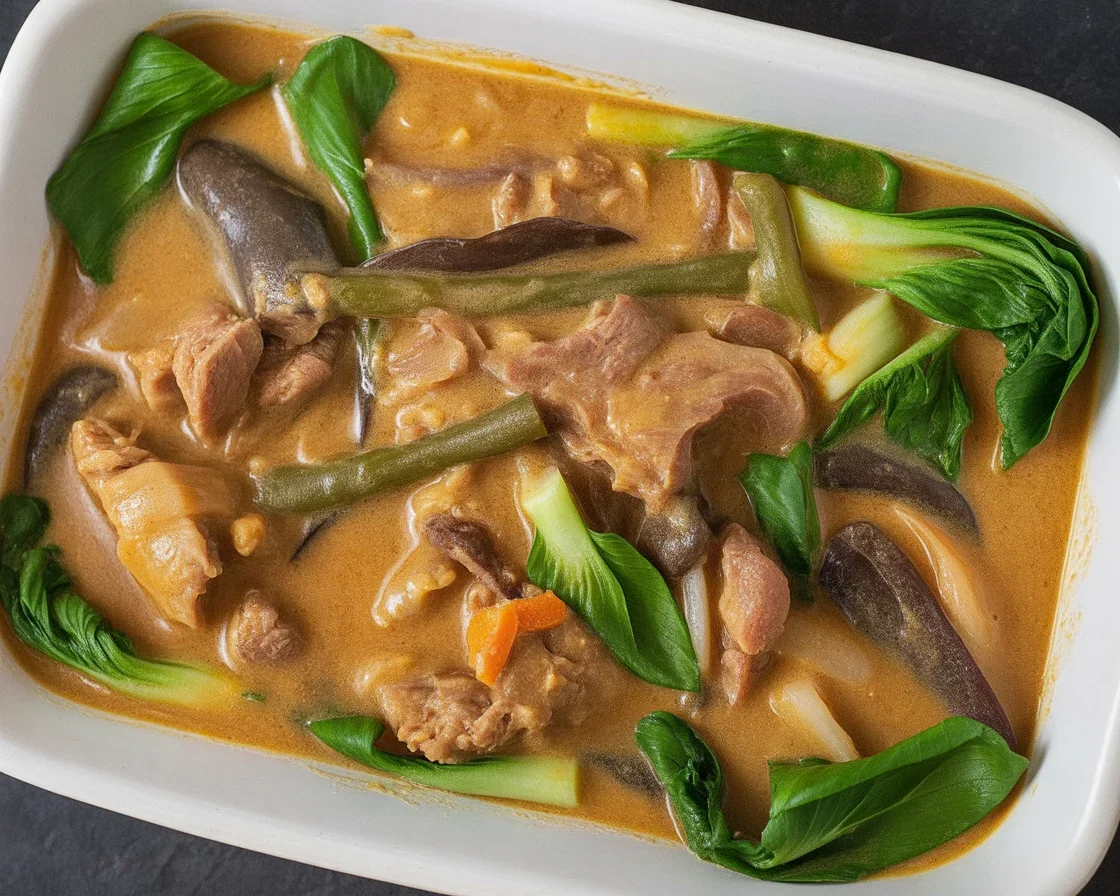 Filipino Crockpot Beef Kare-Kare with rich peanut sauce and tender vegetables.