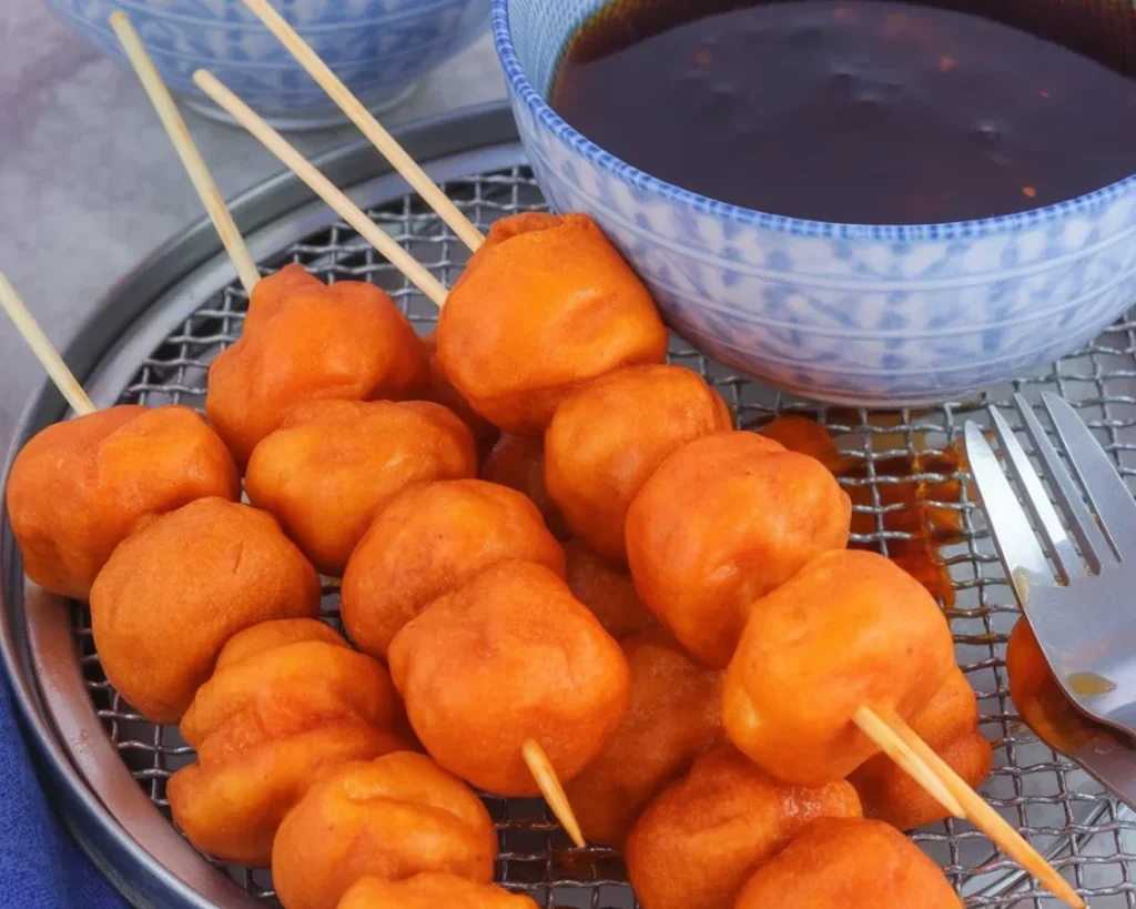 Crispy Kwek Kwek - Deep-fried orange quail eggs served with sauce