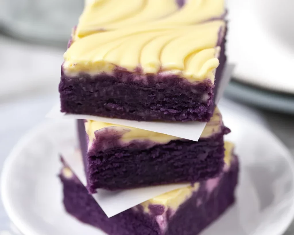 Delicious Ube Cheesecake Bars with colorful purple filling and buttery cracker crust.
