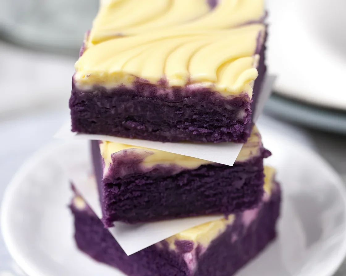 Delicious Ube Cheesecake Bars with colorful purple filling and buttery cracker crust.