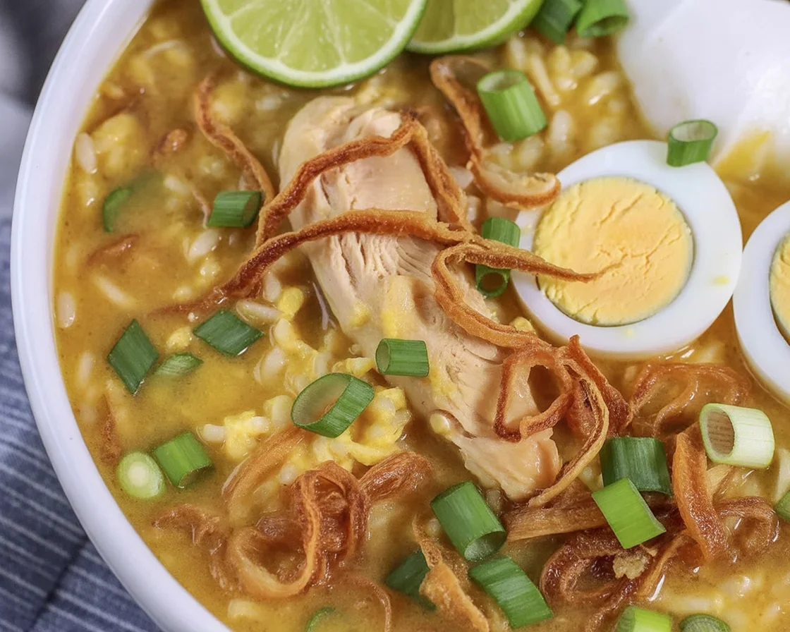 A bowl of comforting Chicken Arroz Caldo, a Filipino rice soup with chicken and spices.