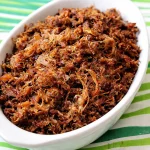 Crispy baked chicken adobo flakes served with a side of rice and vegetables
