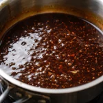 Filipino Sweet Soy Garlic Chicken Bowl served over rice with vibrant garnishes.