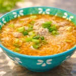 Bowl of delicious Chicken Misua Soup, a comforting Filipino recipe with noodles.
