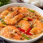 Delicious easy shrimp ginataan with coconut milk and spices in a bowl.