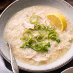 Filipino Shredded Chicken Rice Bowl topped with fresh herbs and spices.
