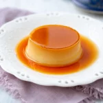 Mini coconut leche flan cups topped with caramel for a sweet dessert.