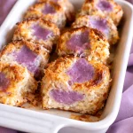 Ube French toast topped with homemade coconut syrup and berries.