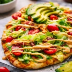 Adobo Chicken Flatbread Pizza topped with chipotle sauce and fresh ingredients